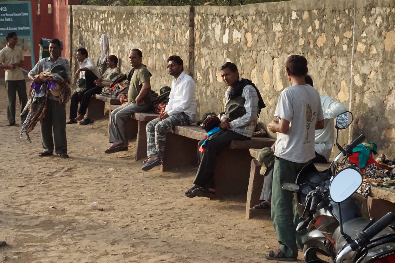 Hawkers selling hats and scarfs near the entrance.