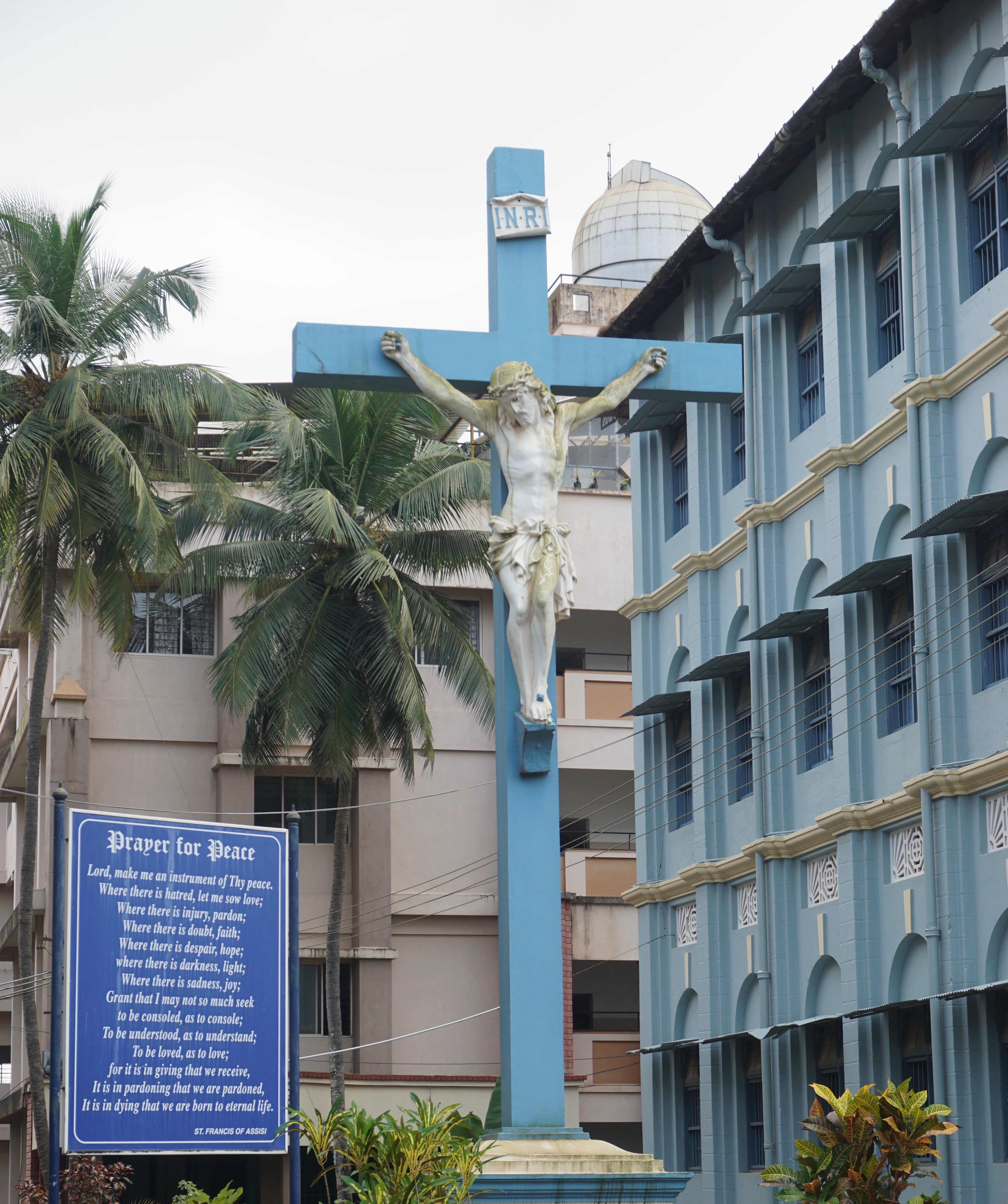 St. Aloysius High School and St. Aloysius College are on the left and right side of this sculpture. The chapel is the adjacent building to the left.