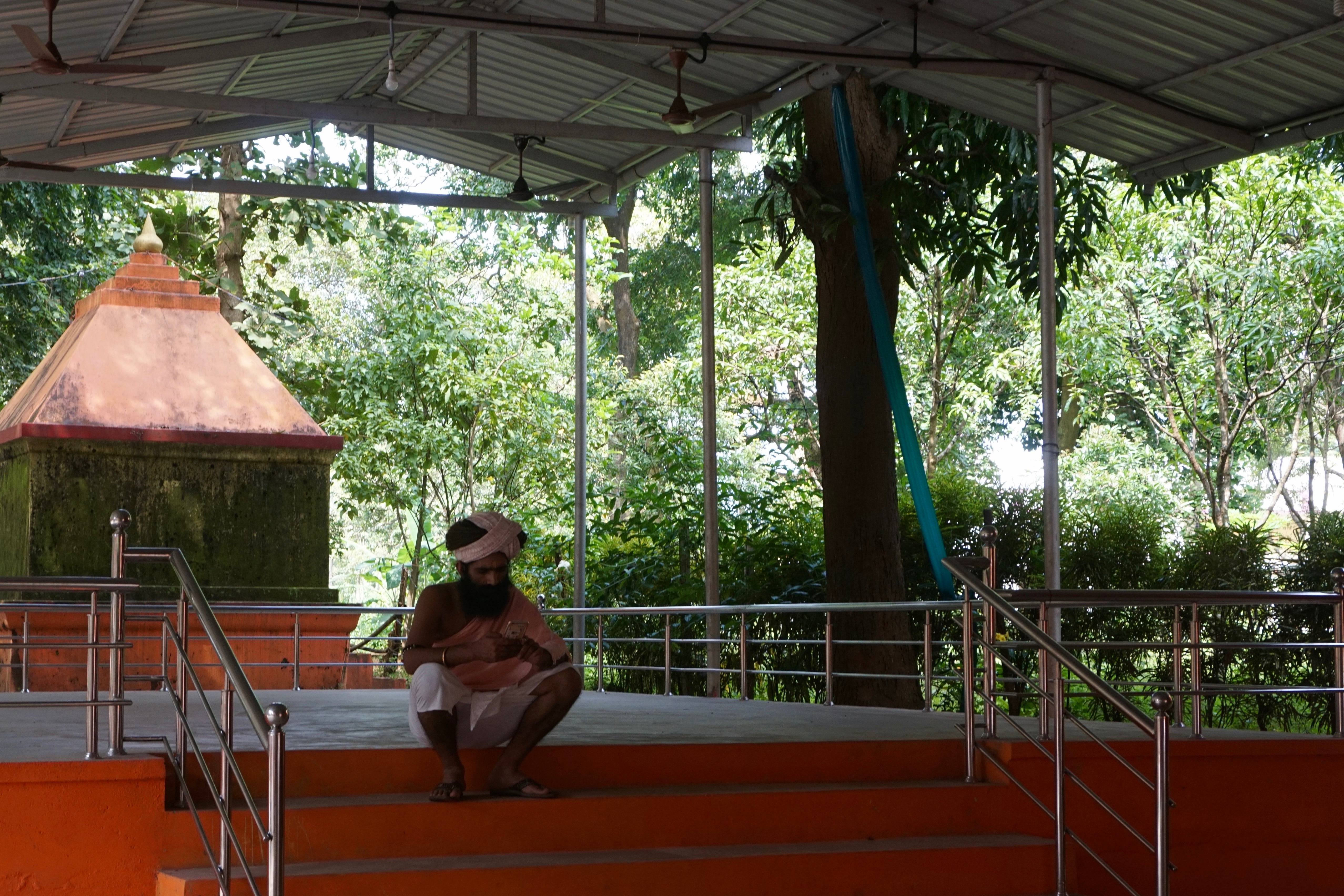 A sadhu resting inside the ashram courtyard.