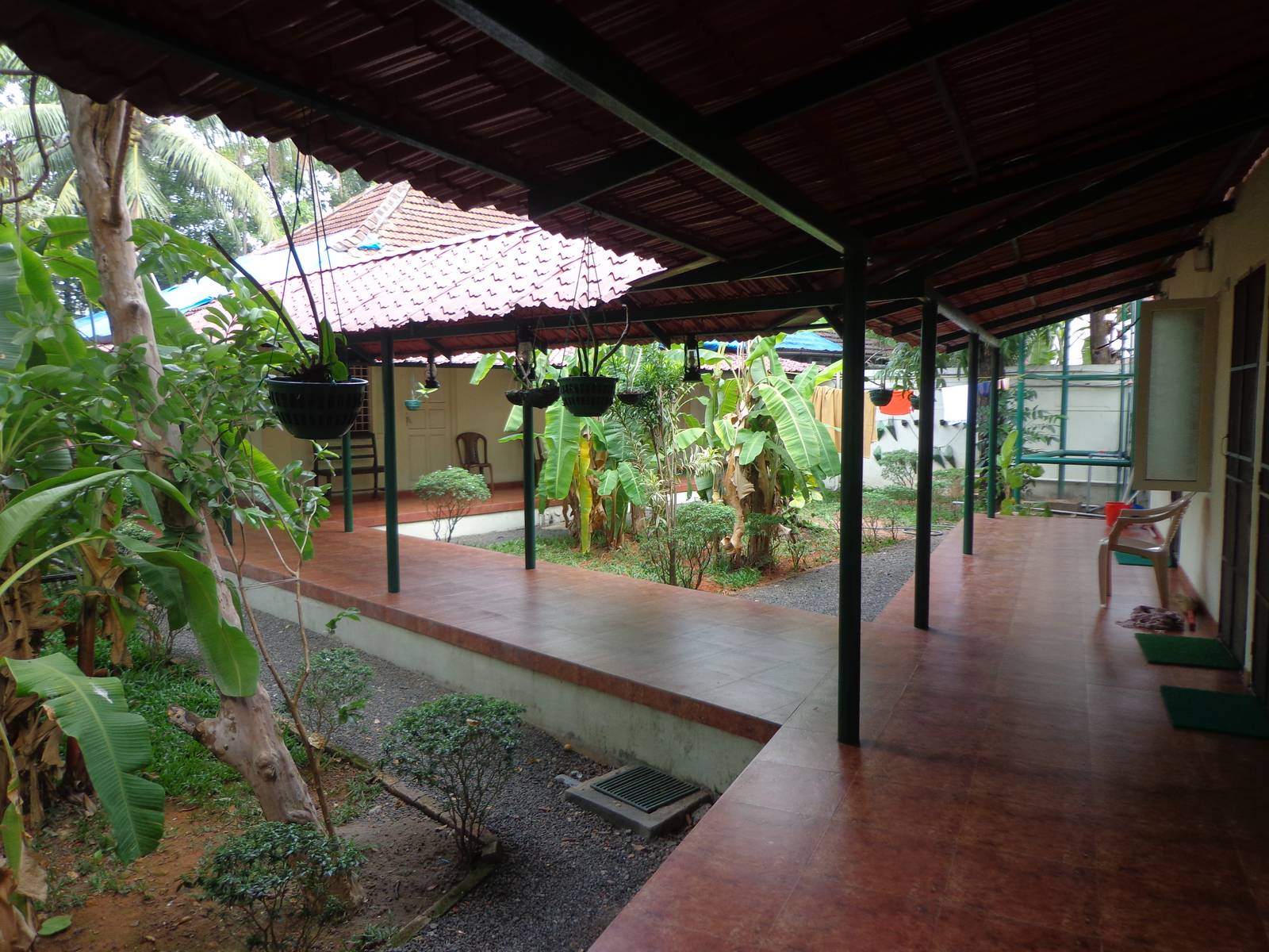 I did not expect Palm Grove to be a farmhouse. The hanging tubs have orchids growing out of them.