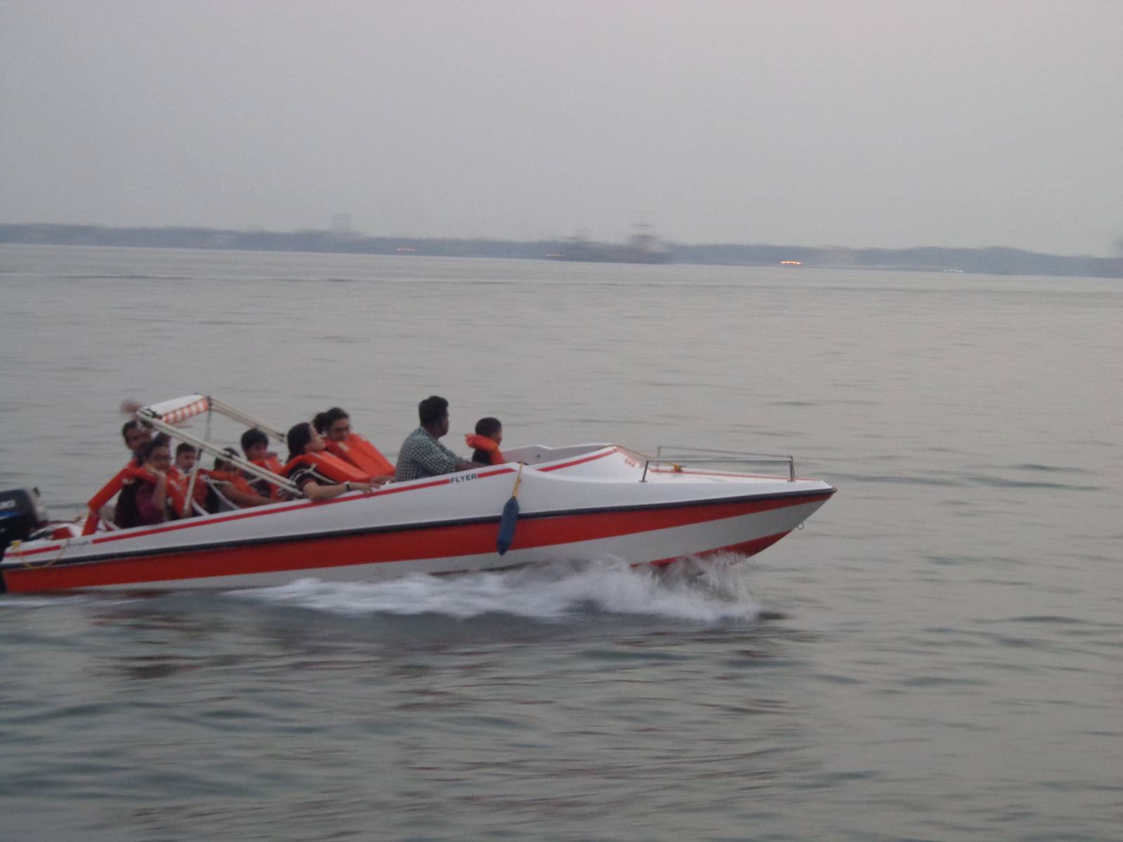 A speedboat zoomed past our slow ferry.