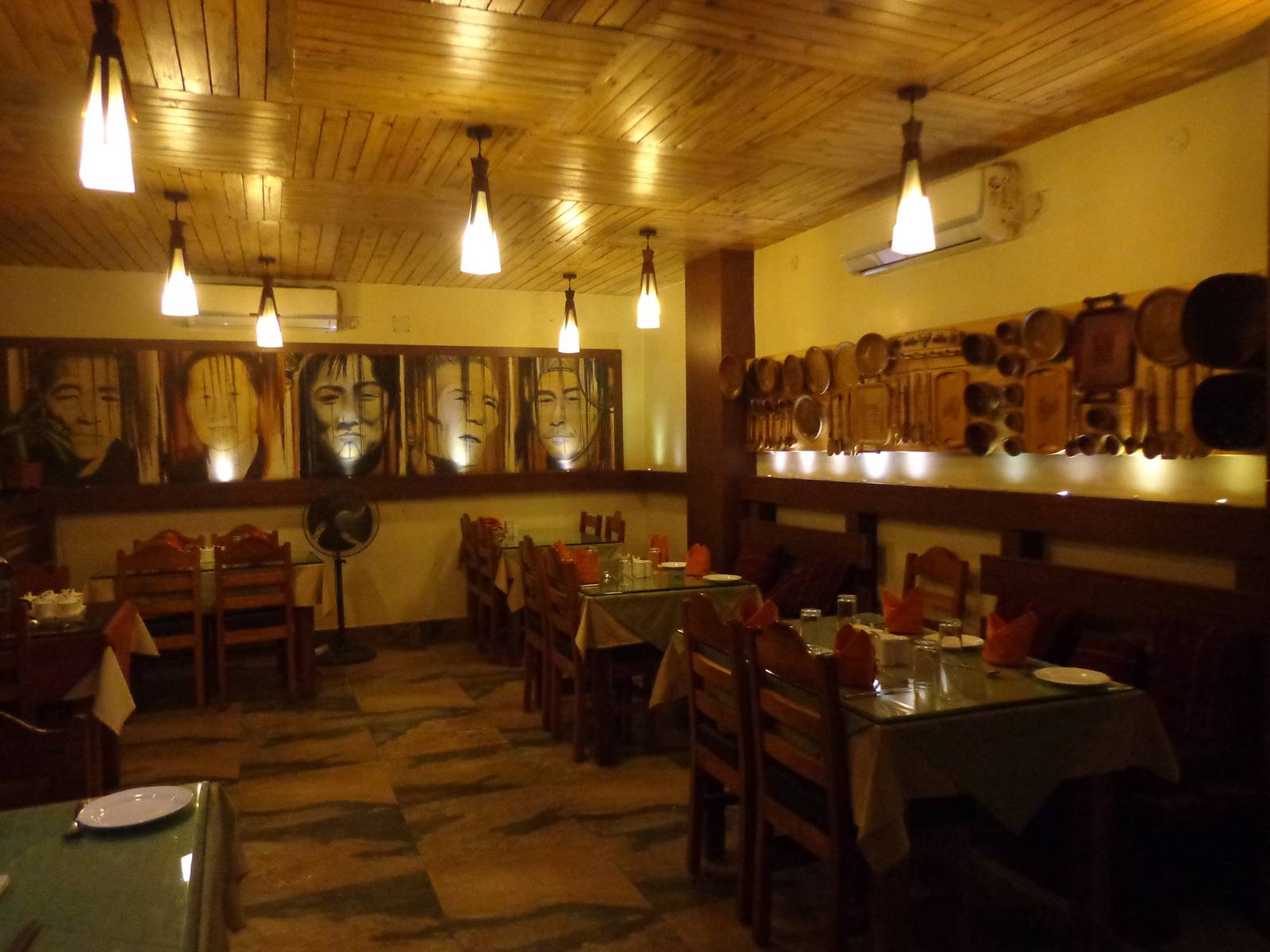 I don&rsquo;t know what the portraits represent. The other wall had wooden Naga style utensils.