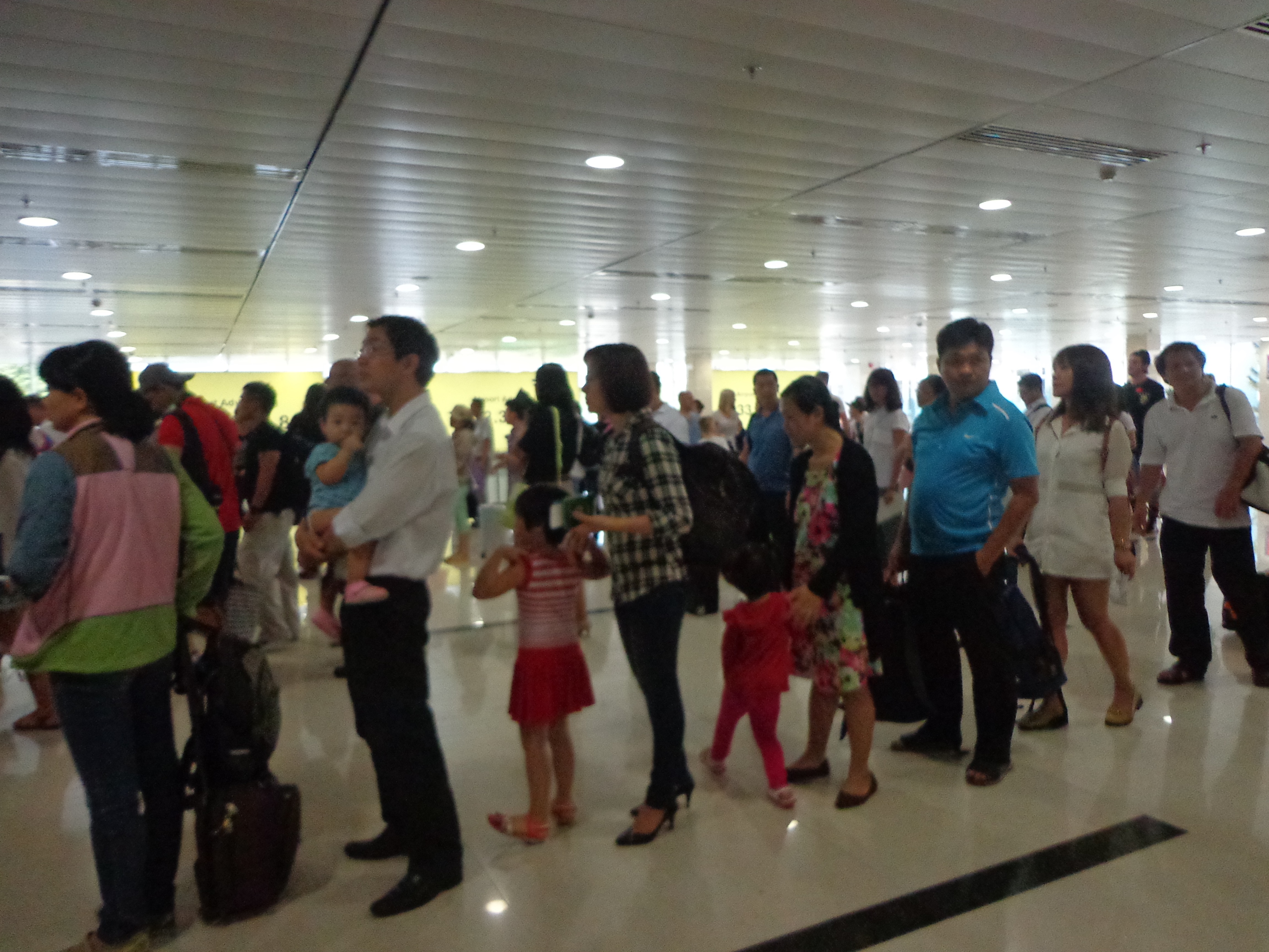 People somewhat queued up before the security checking counters.