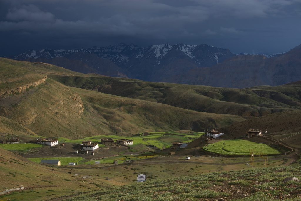 Komic village, basking in the spotlight created by the Sun and a small break in the clouds.