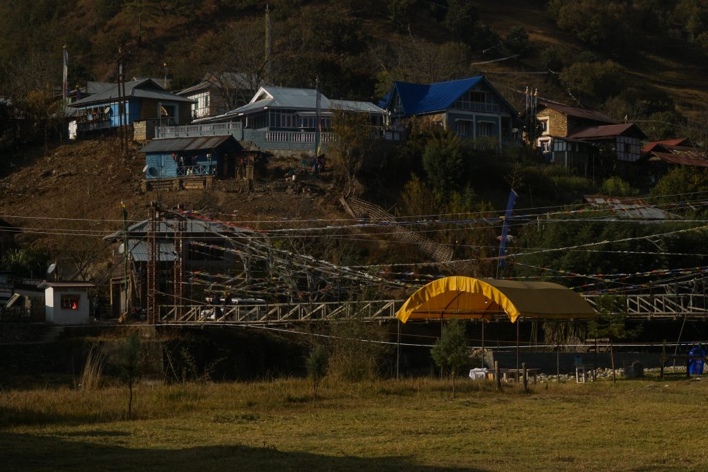 Sangti village. The colourful canopy is an open dining tent on the camping ground.