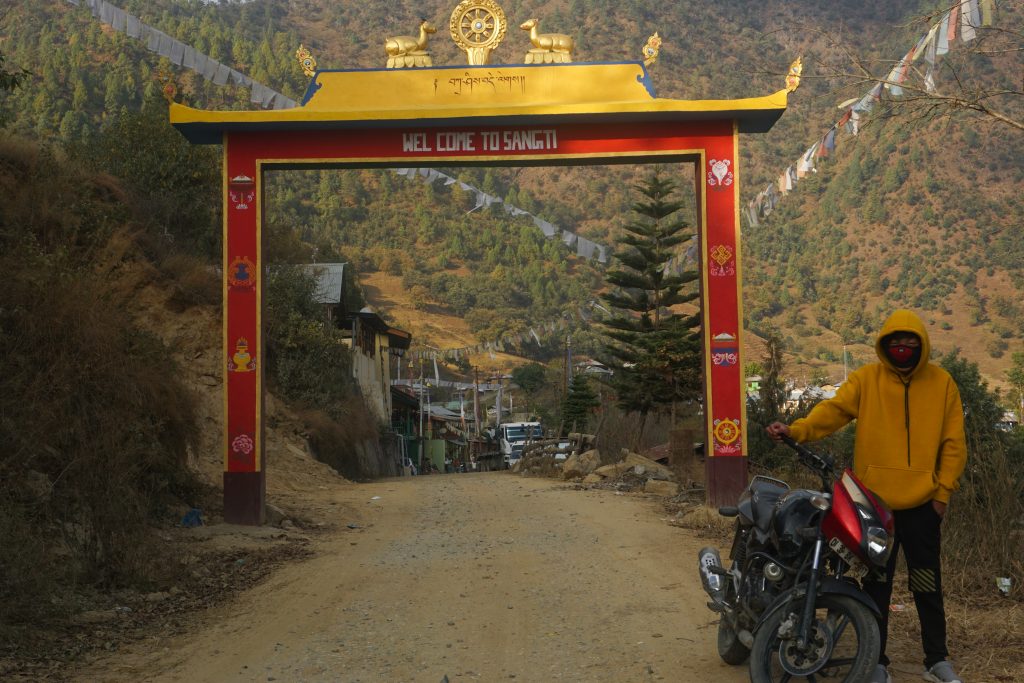 Sangti village gate. Notice the poor condition of the road. Whenever a large vehicle overtook us, we were greeted by a puff of dust.