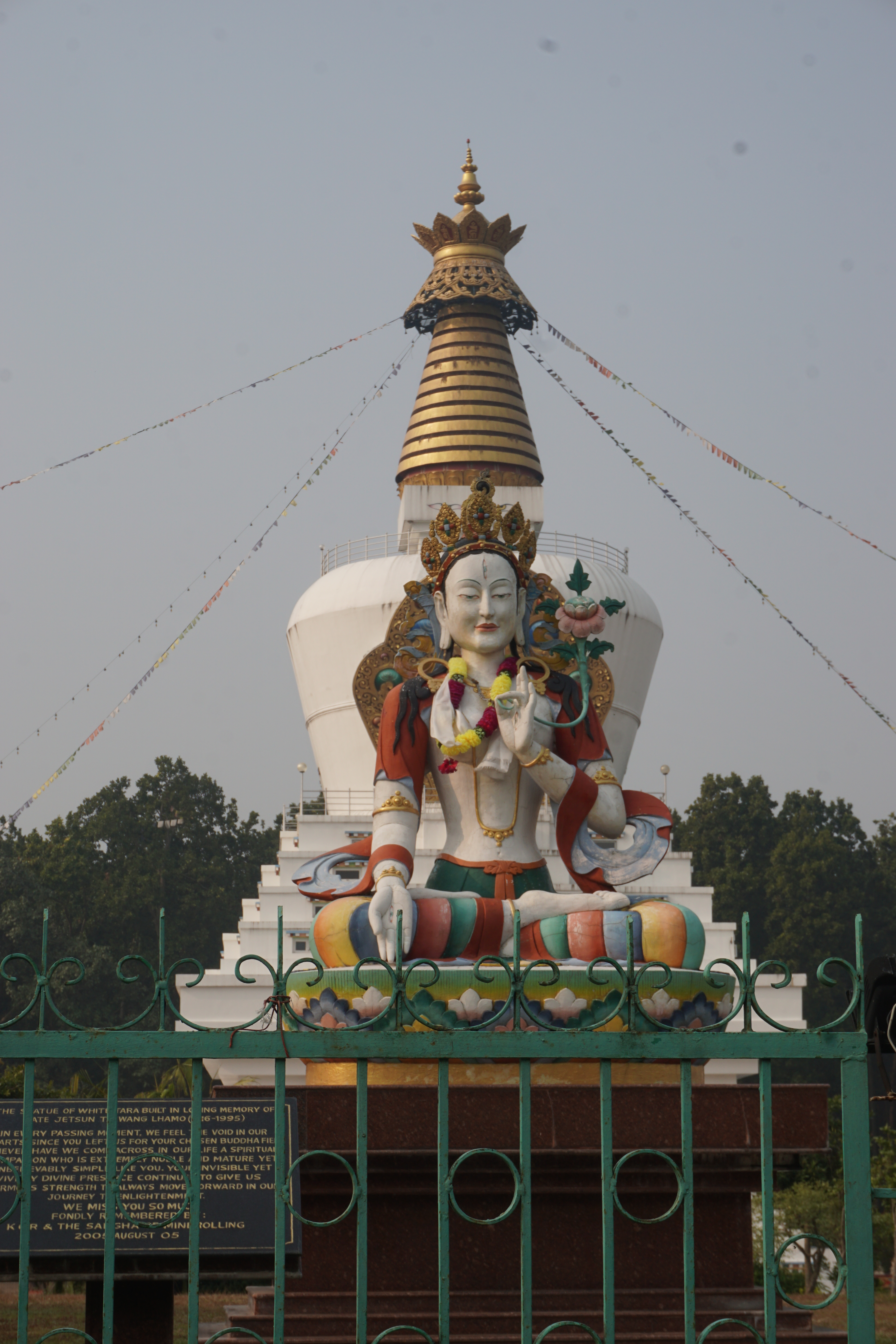 Statue of White Tara with Mindrolling&rsquo;s Great Peace Stupa in the background.