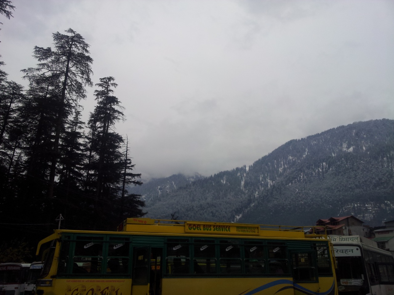 This picture is taken at Manali bus stand. All around me I could see white mountains covered in white clouds.
