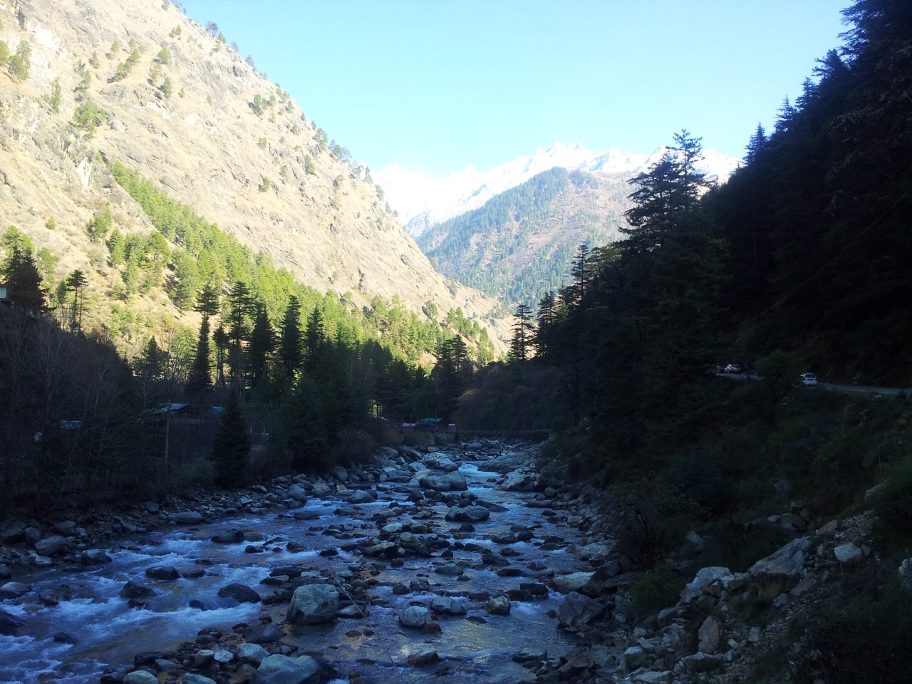 Parvati River, the Annapurna range and a bridge connecting a lone resort on the other side of the river.