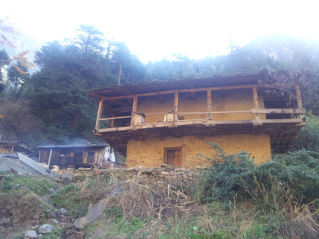 Two-storey building made of wood and clay. I have seen similar buildings in southern West Bengal&rsquo;s villages.