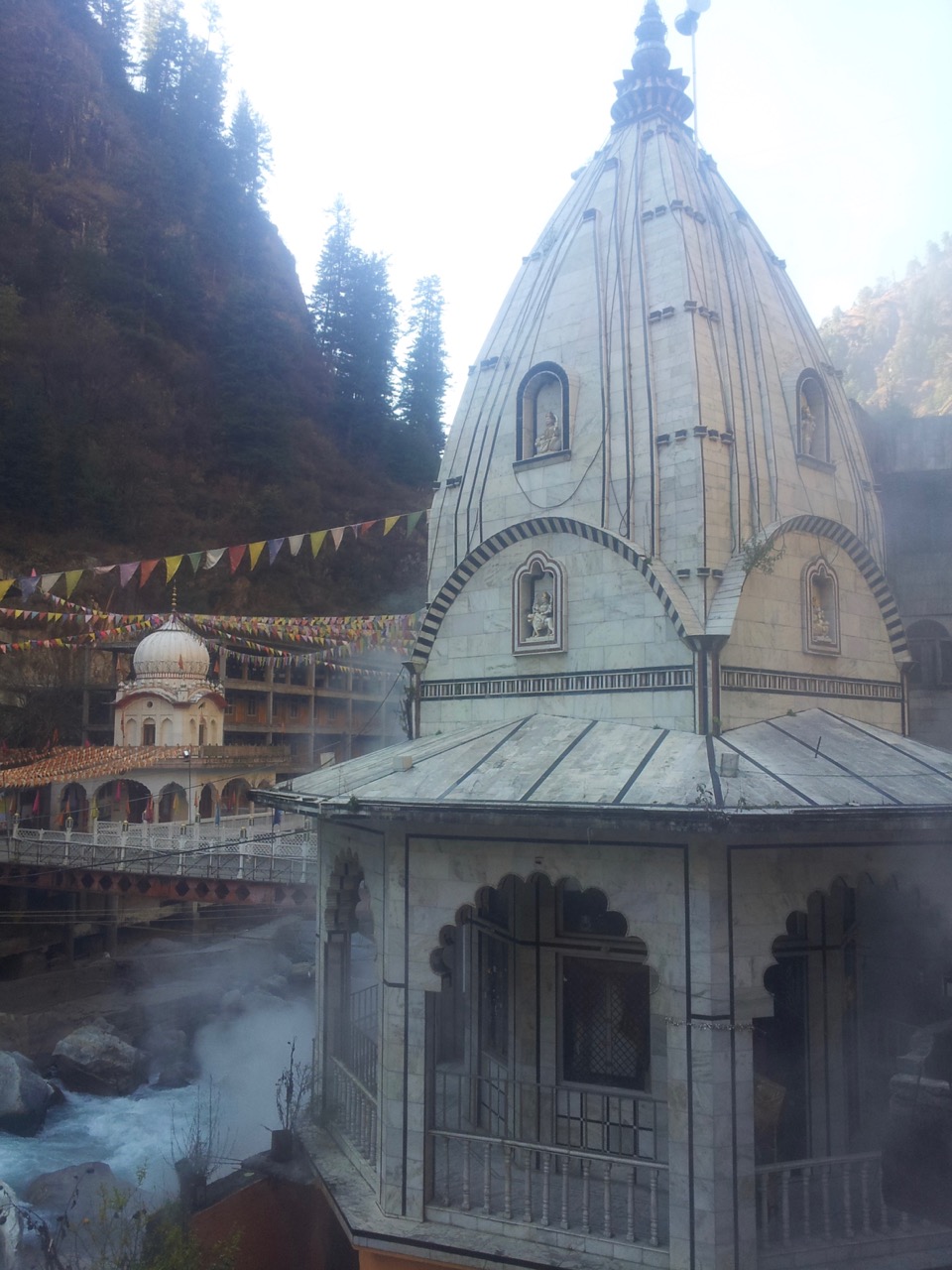The Shiva temple and the Gurudwara. The fumes are from the natural hot water springs found in Manikaran.