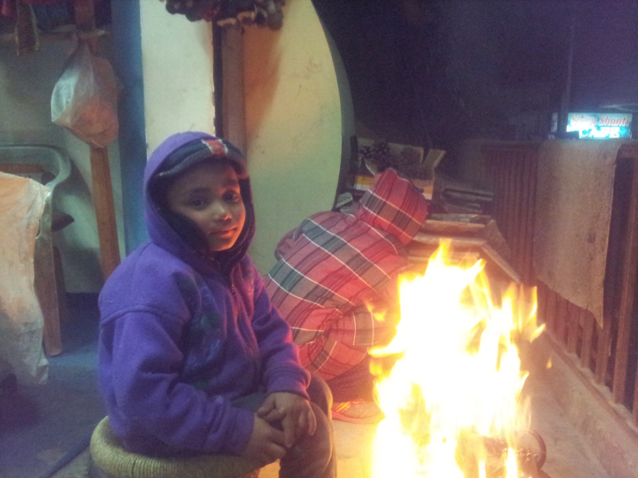 Sushant, the kid of the shopkeeper across my place posing in front of the fire. He studies in first standard and won&rsquo;t be getting his holidays before 25th of this month.