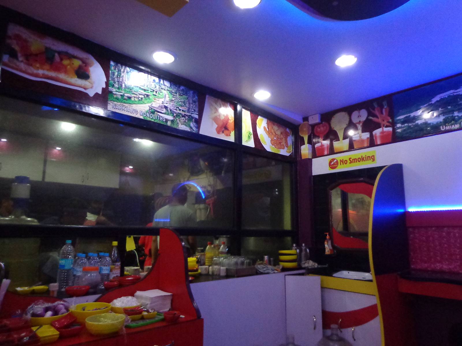 The colourful interior of Fast Spin. The kitchen is visible through the glass.