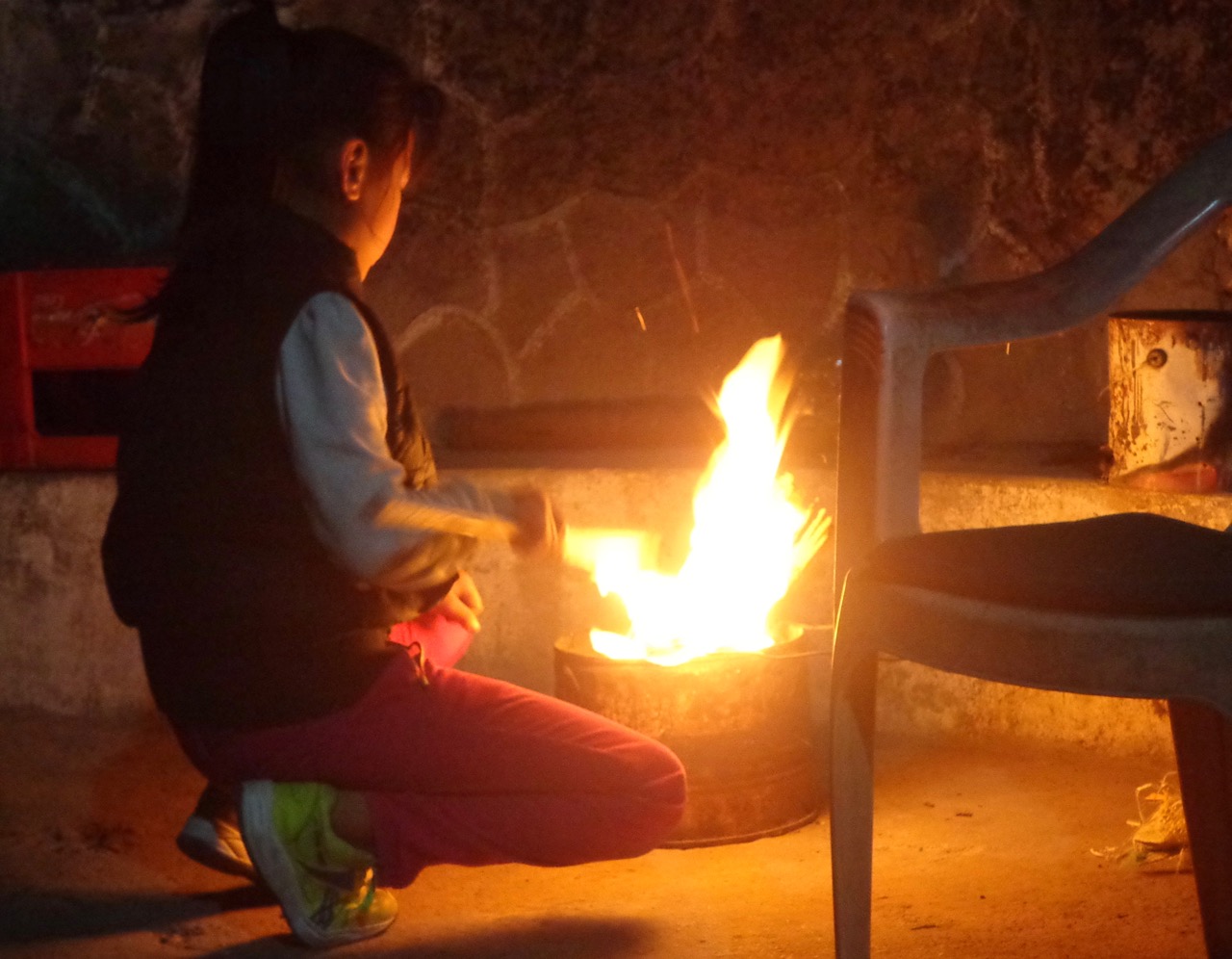 The kid finally managed to light up the wood. She said that her finals were over and when the school will open after three months, she will be in sixth grade.