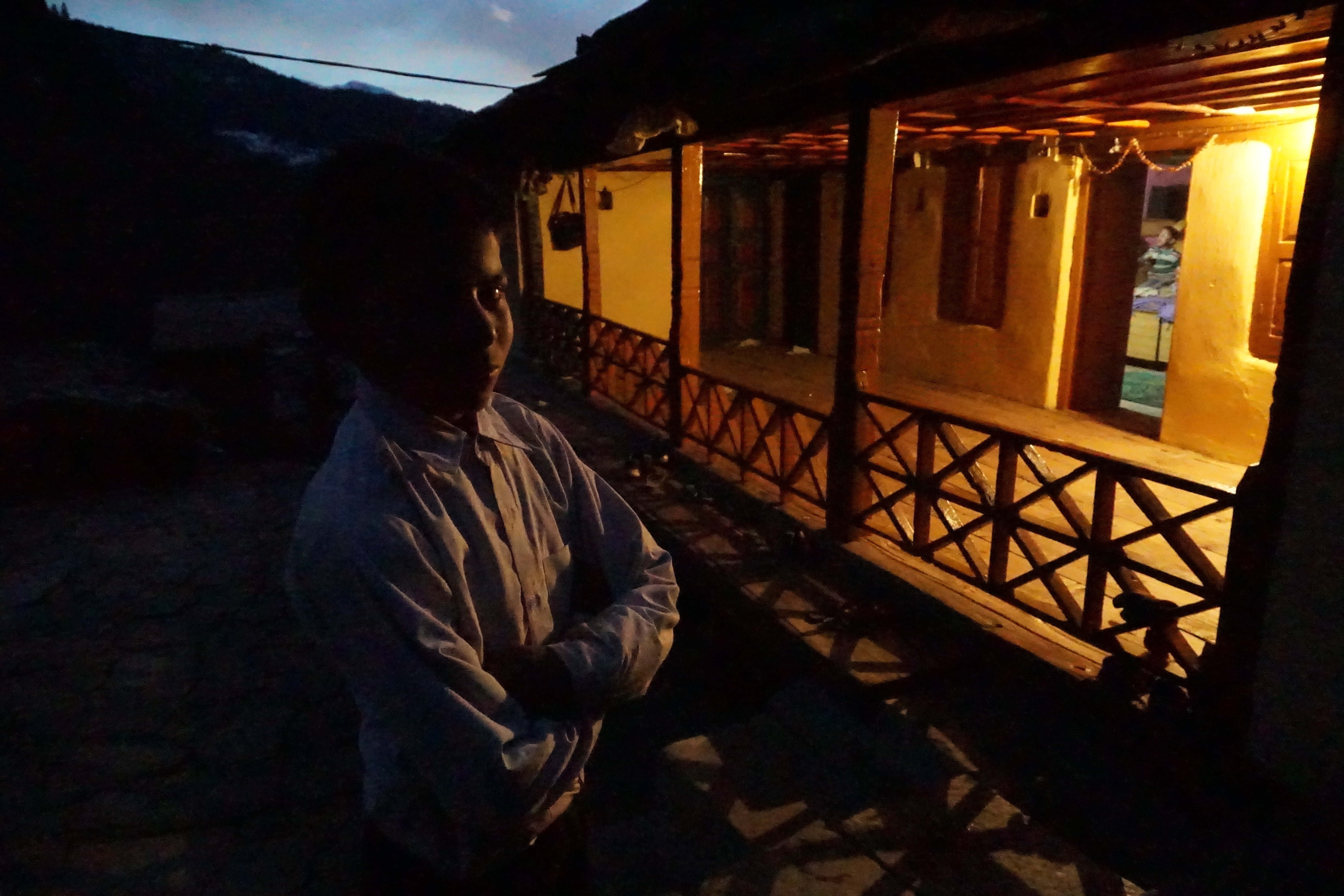 One of the kids, who was playing cricket, posed in front of his house.