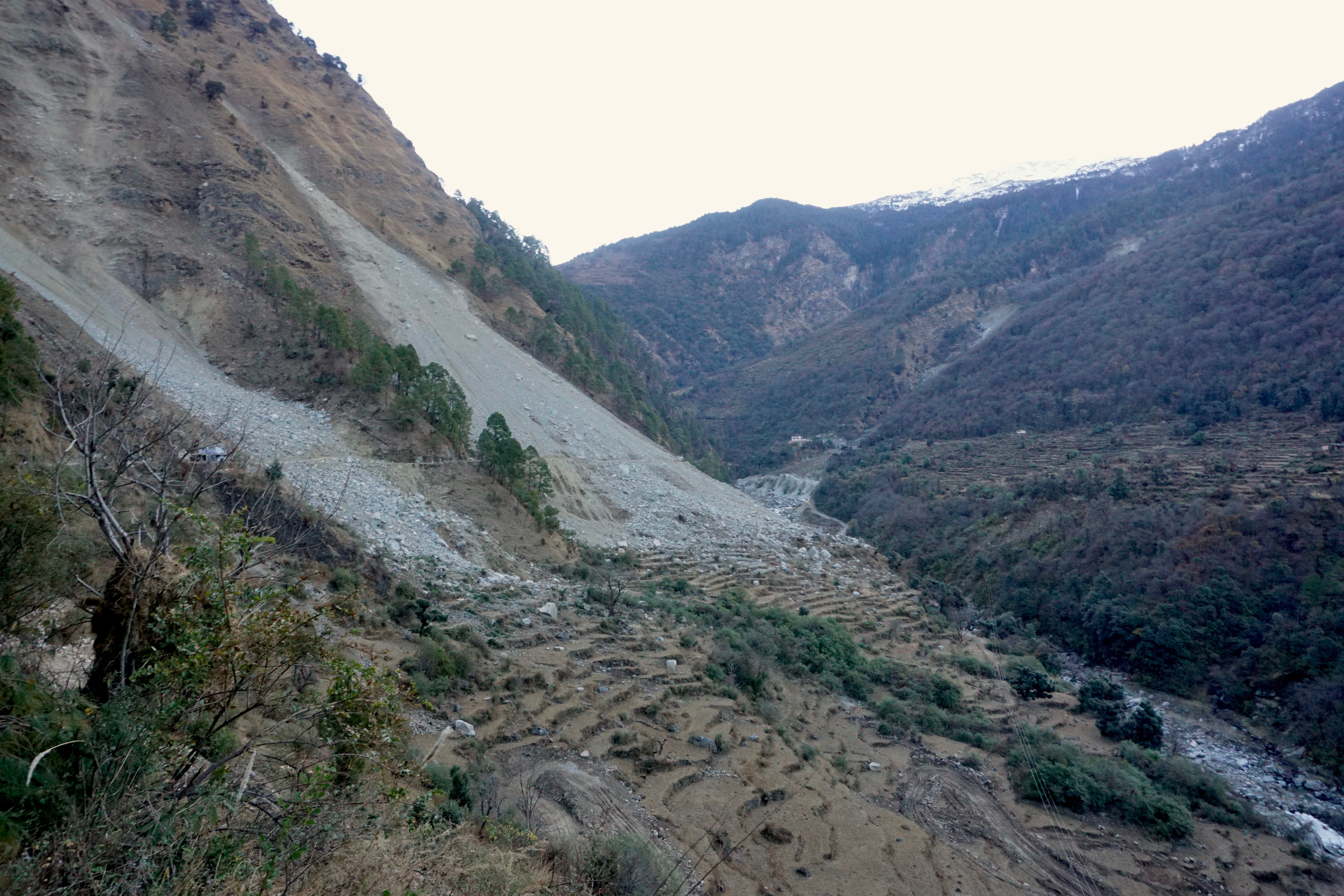 It is hard to sense the scale of the landslide from a picture alone. For reference, look at the road that passes along the left slope at around mid-point.