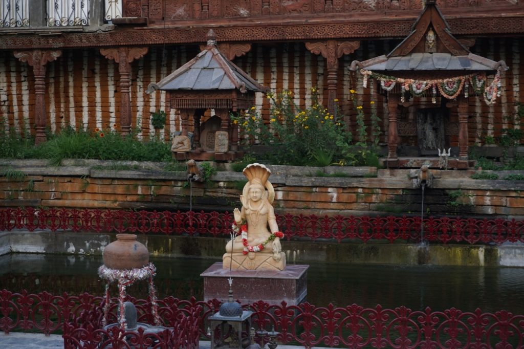 Right behind the Chandika Devi temple was a Shiva temple and a pond. Some bit of modernisation has taken place. Shravan said that when he was a kid, this place did not have fences and the pond had fishes. Somehow the concrete and iron doesn&rsquo;t go with the retro-styled temple in the back.