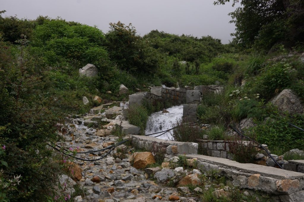 We had to cross this water stream—possibly Chitkul&rsquo;s source of drinking water—to reach the base of the adjacent hill.