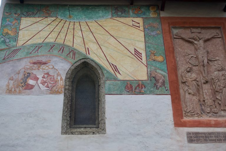 A sundial on the wall of the Chapel of Archbishop Leonhard von Keutschach.
