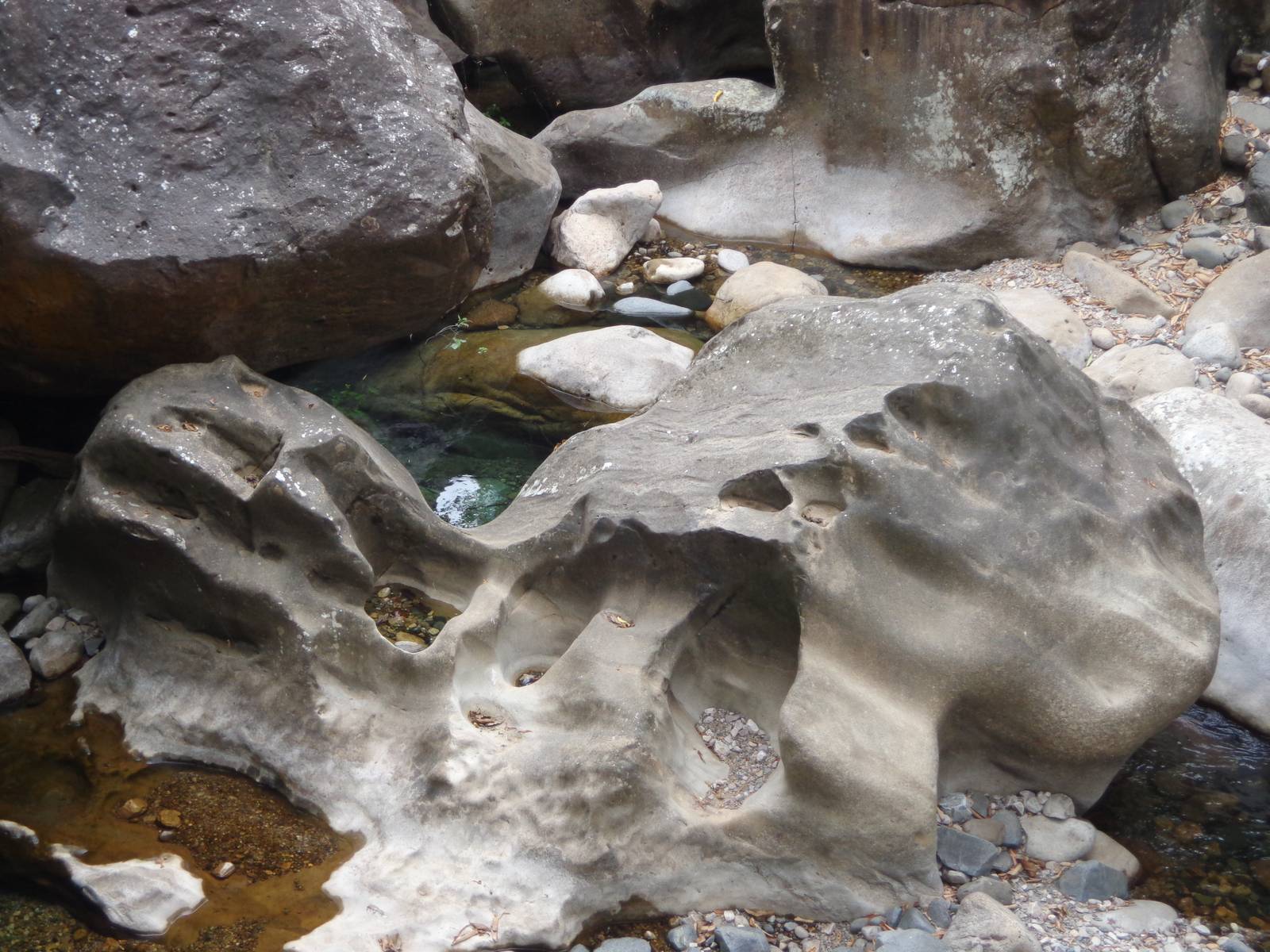 Years of falling water has caused cavities in a rock below the bridge. In summer this place is completely submerged.