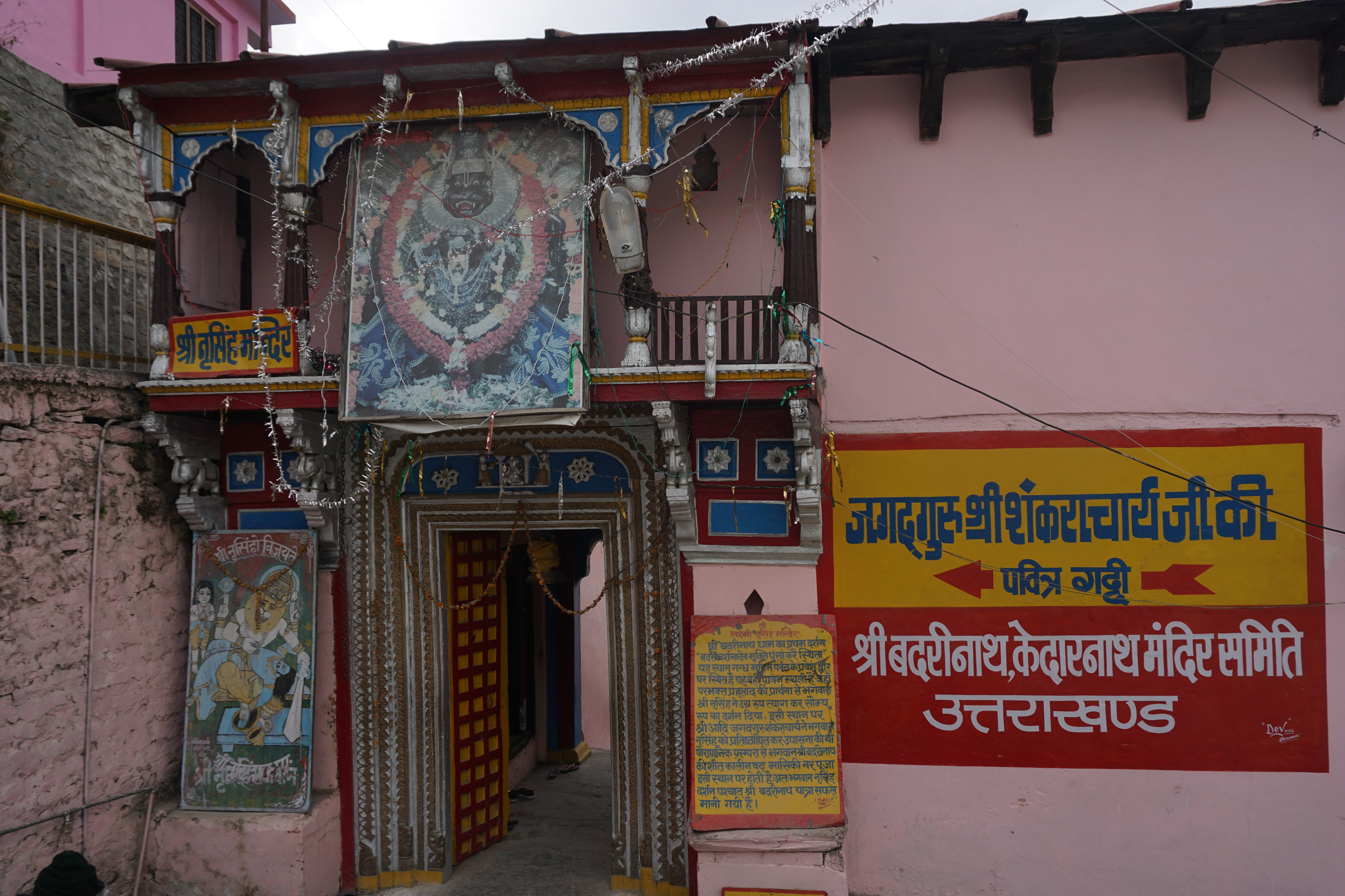 A man offering prayers outside a pub. Maybe he is praying for good business and prosperity.
