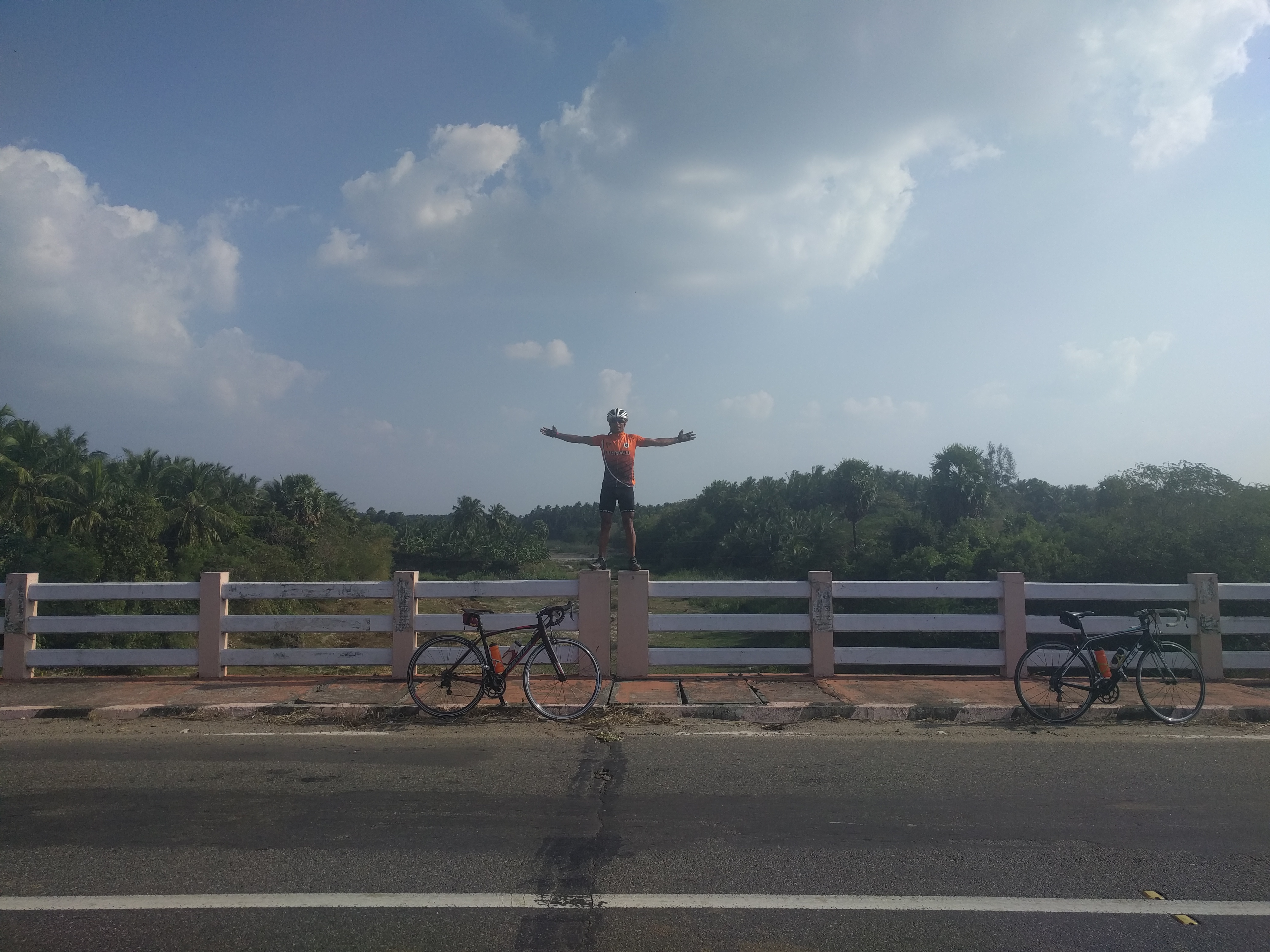 Manjeet posing on the railing of the bridge.