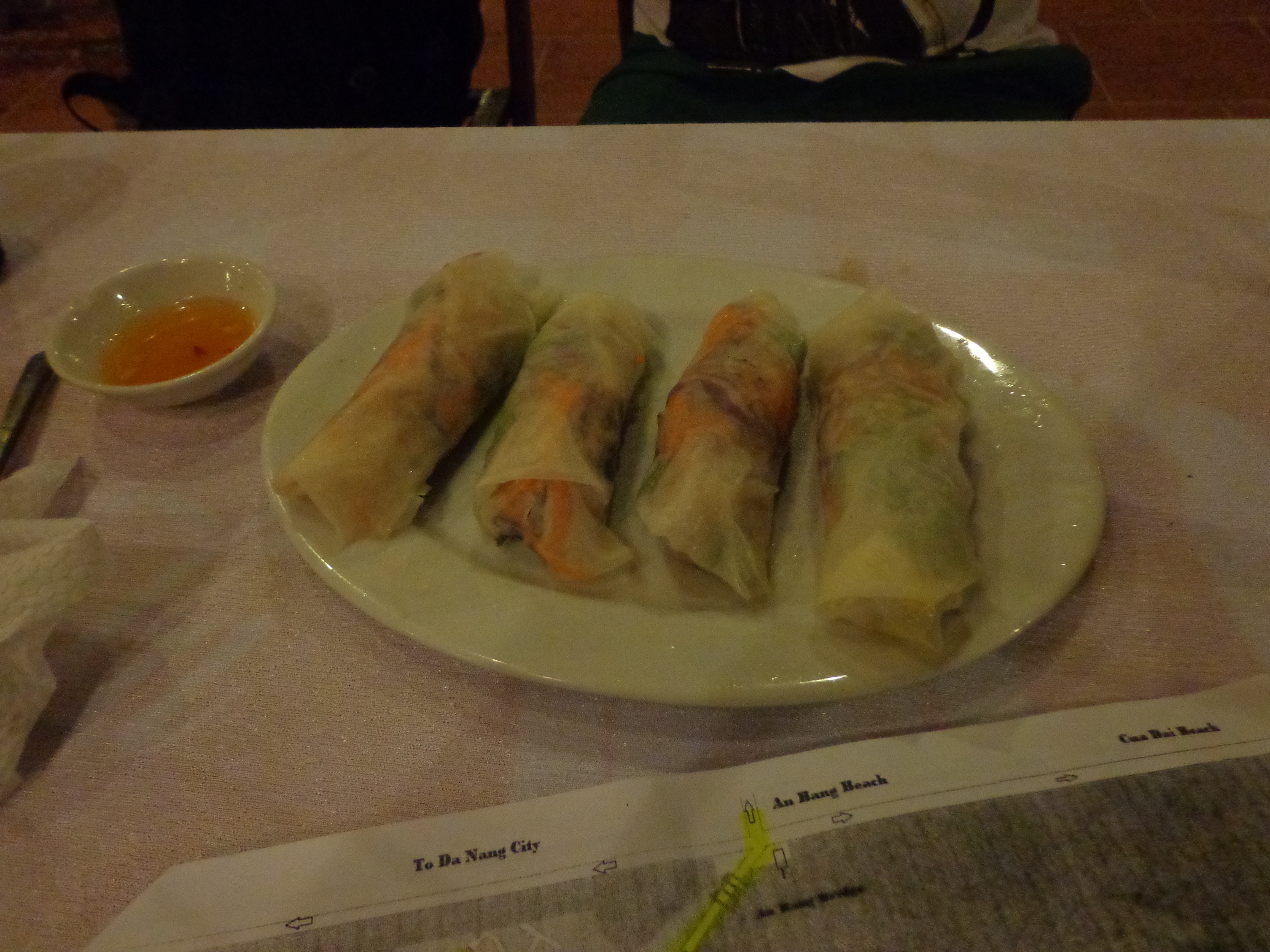 Fresh pork spring rolls. This one came well assembled. We just had to dip one in the sauce and bite into it. The map I was using to navigate is also visible.