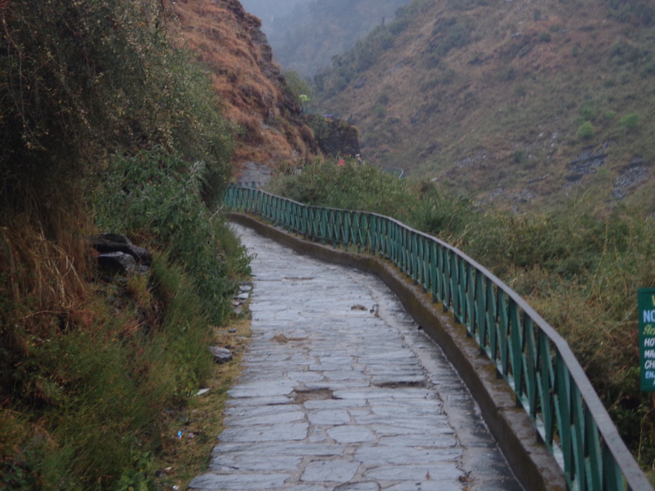 The entire trail is paved with local slate stones. There is also a railing for safety purposes.