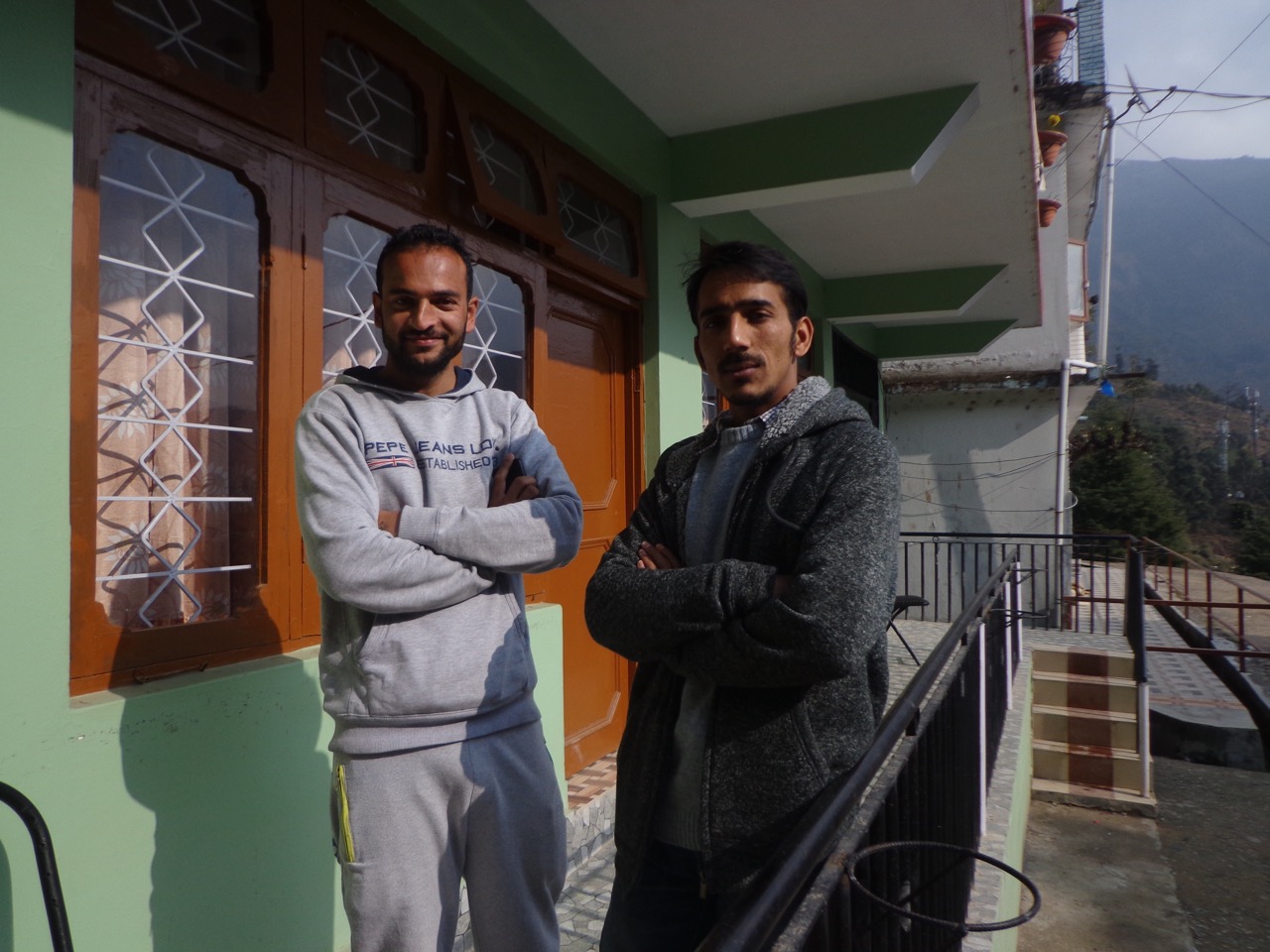 Vinay and Ganesh posing in front of the staff room of Backpackers Inn.