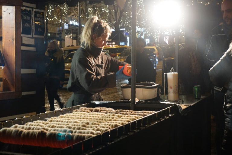 A Czeck girl making Trdelníks in the Christmas market.