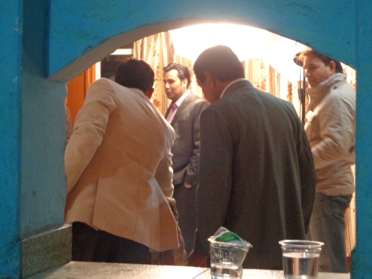 I took this photo of a photo session with the groom through the counter that is used to pass food from the kitchen to the restaurant.