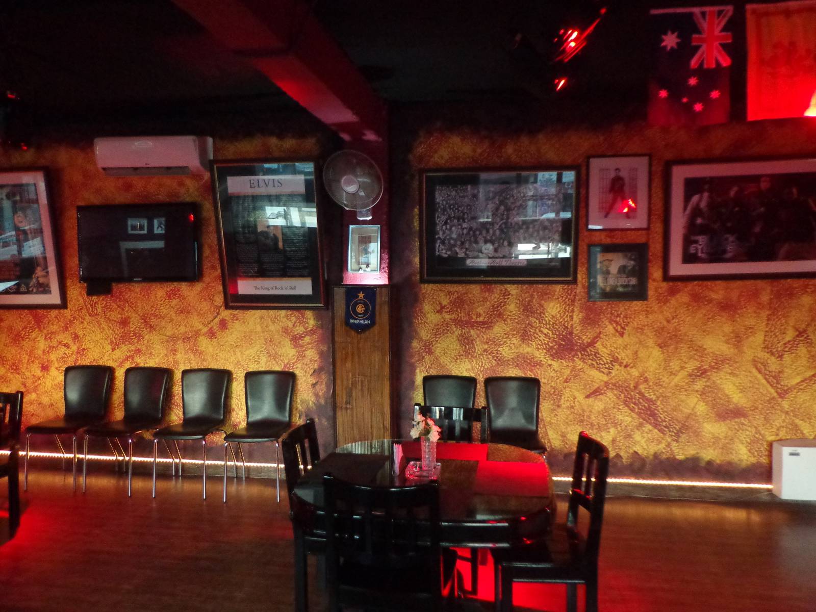 The walls are decorated with posters of musicians.