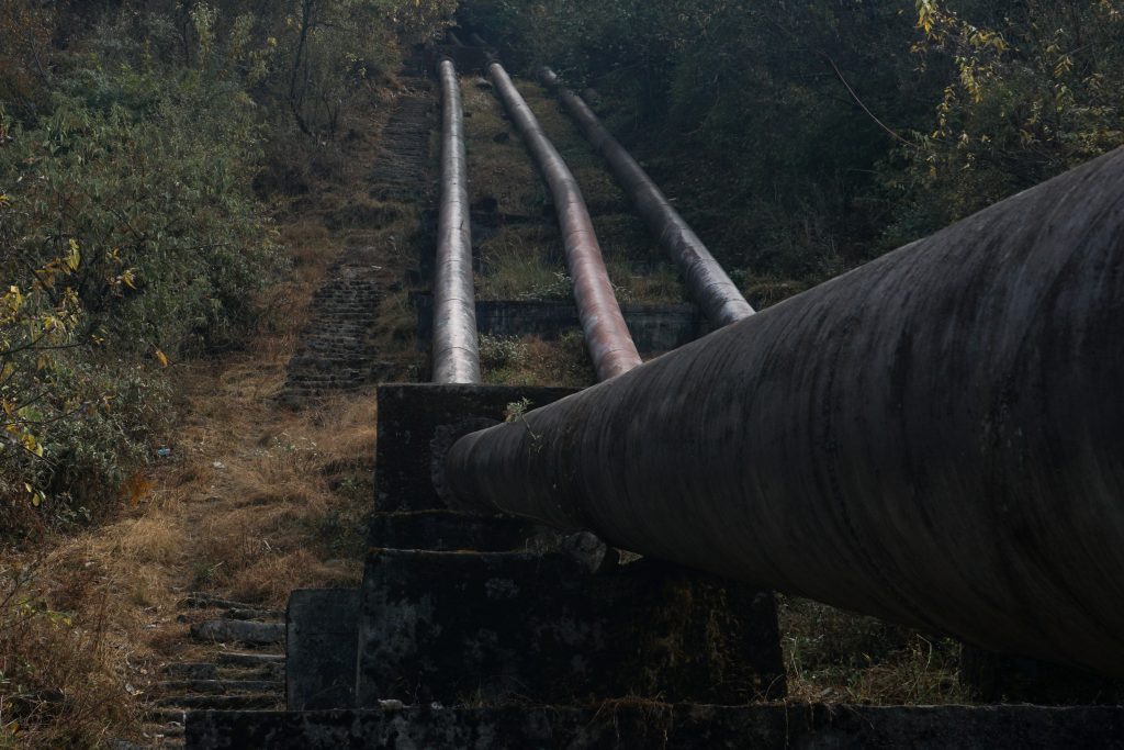 Pipes and stairs connect the power station with a reservoir above.