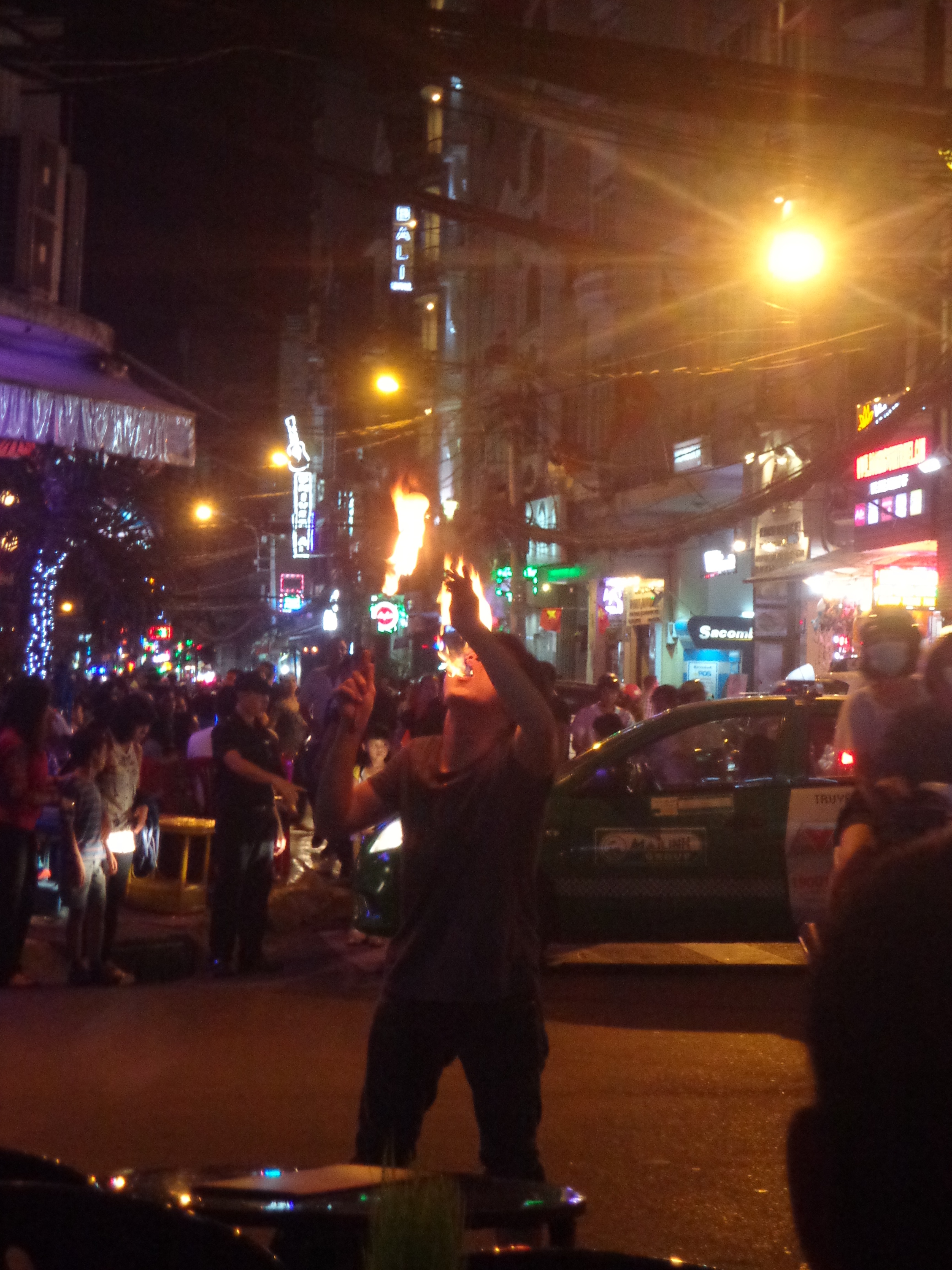 A kid performing with gasoline and fire.