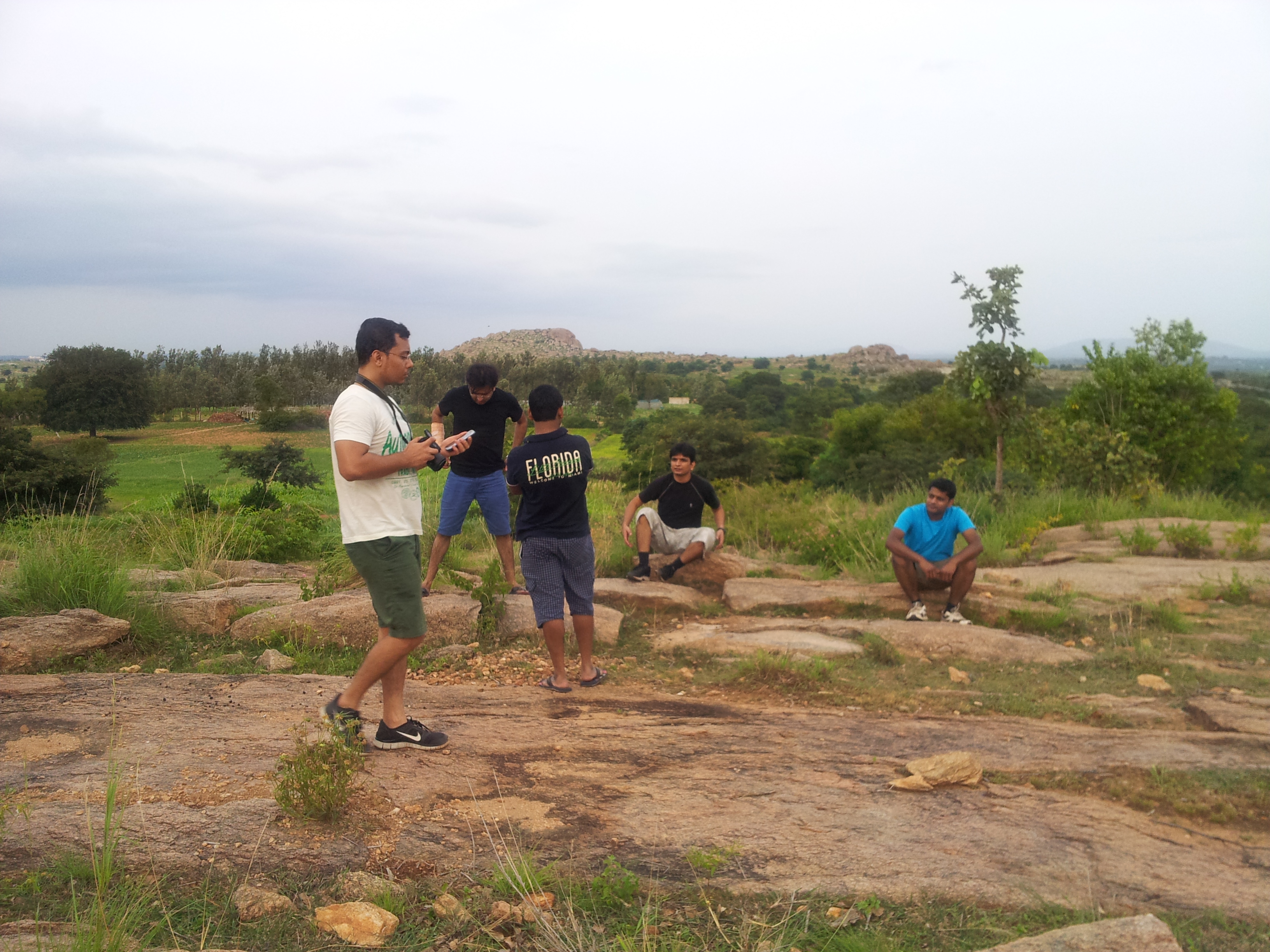 The red soil is often interrupted by uncultivable stone mounds.
