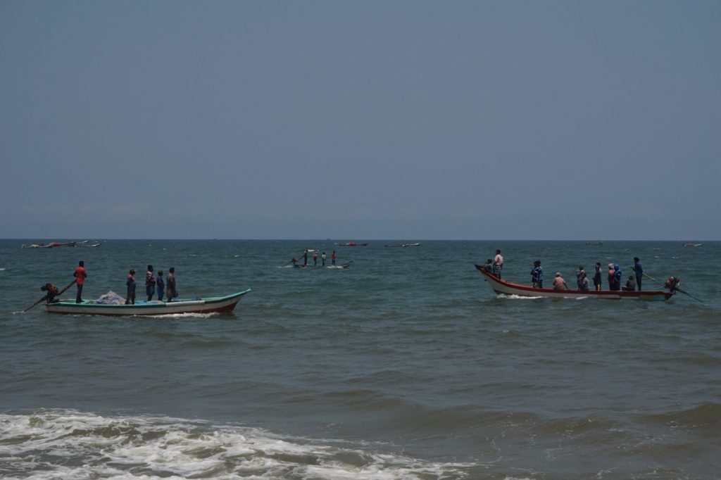A lot of fishing boats paced over the waters along the stretch of the beach