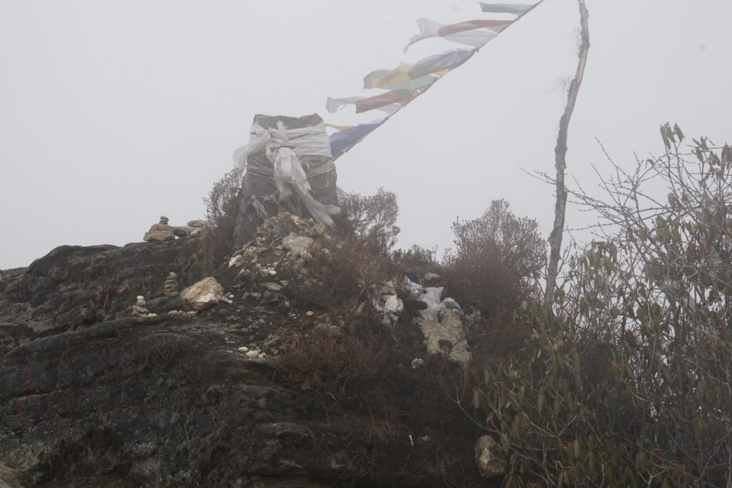 At times it got foggy. These prayer flags fluttered in the chilly wind. There was a bundle of hairs placed as offering. I couldn&rsquo;t figure it out if they belonged to human beings or yaks or mules.