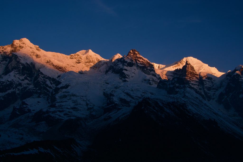 Sun hitting the Kabru peaks.