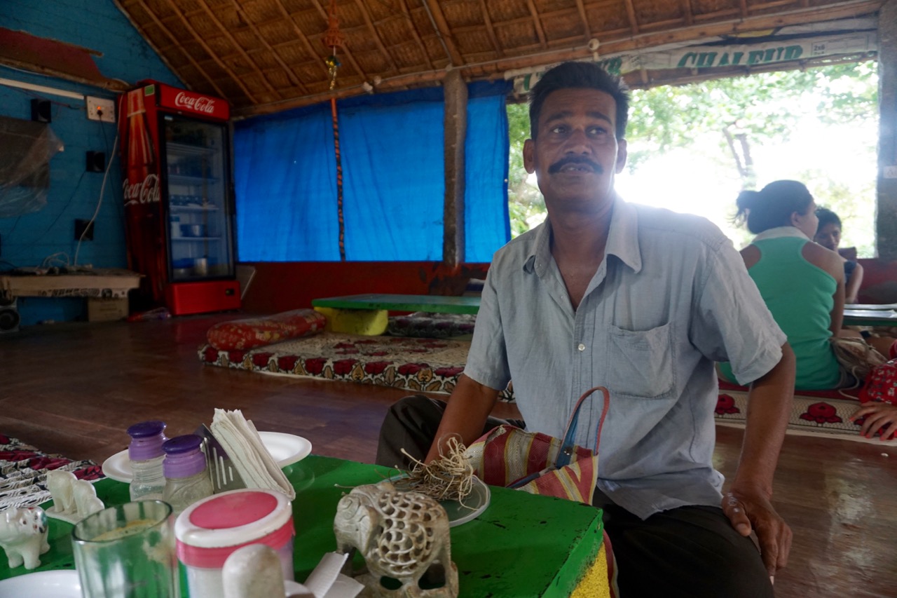 Mr. Basha marketing his stone carvings. He didn&rsquo;t hesitate to disclose the fact that he charges disproportionate prices from foreigners. He had left his container of trinkets on our table. We asked one of the kids to send him back.