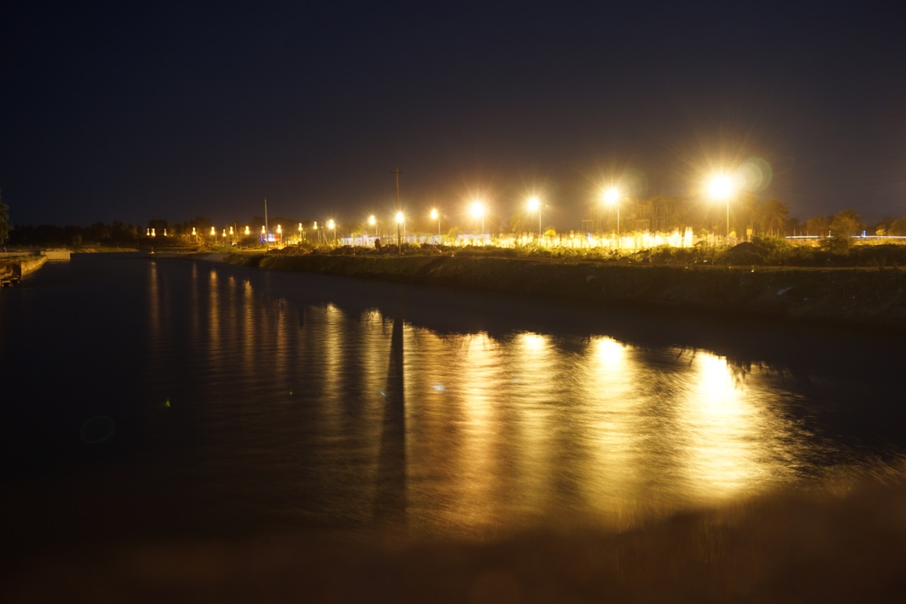 The canal near railway station illuminated by the street lights.